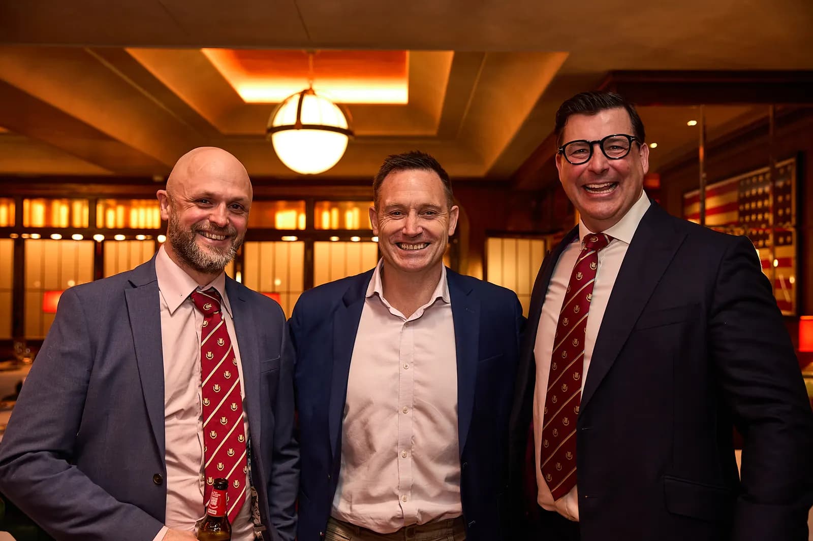 Three guests in club ties in the dining room