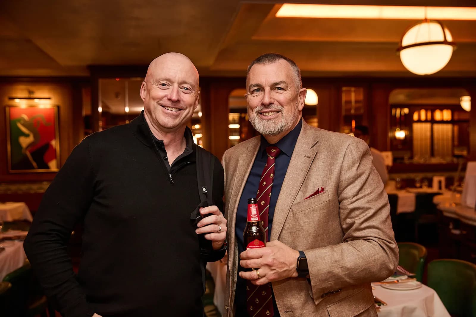 Two guests with drinks at the reception