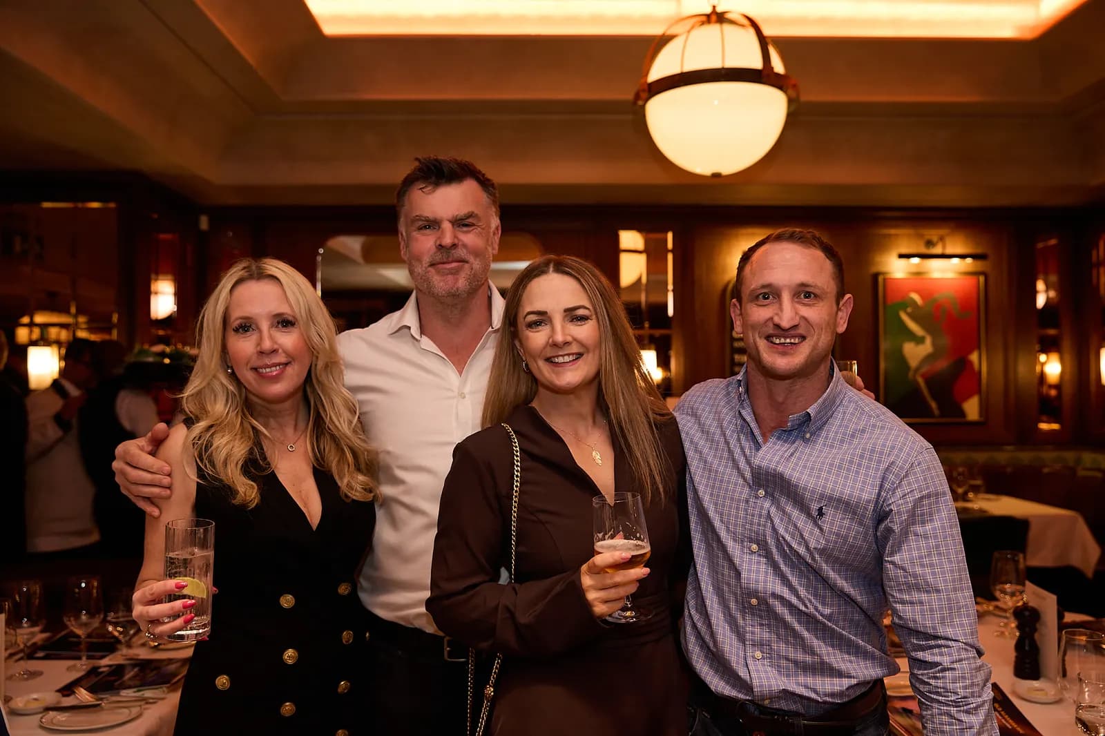 Four guests posing together before lunch
