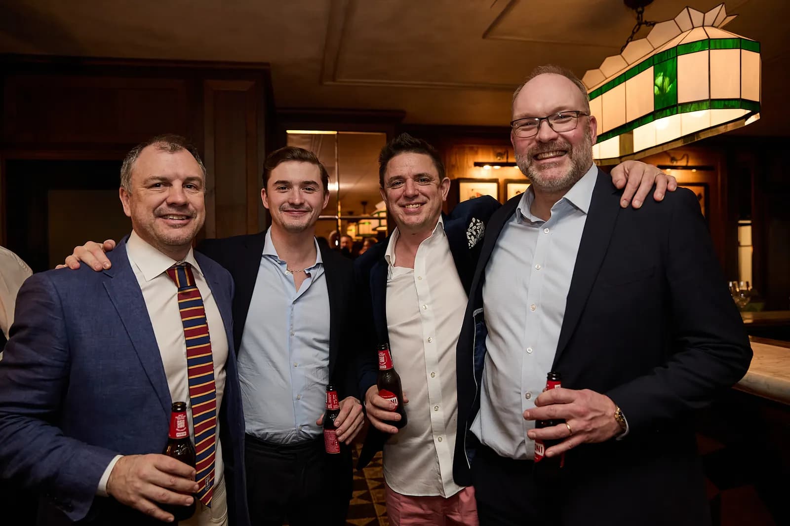 Four friends with drinks in hand