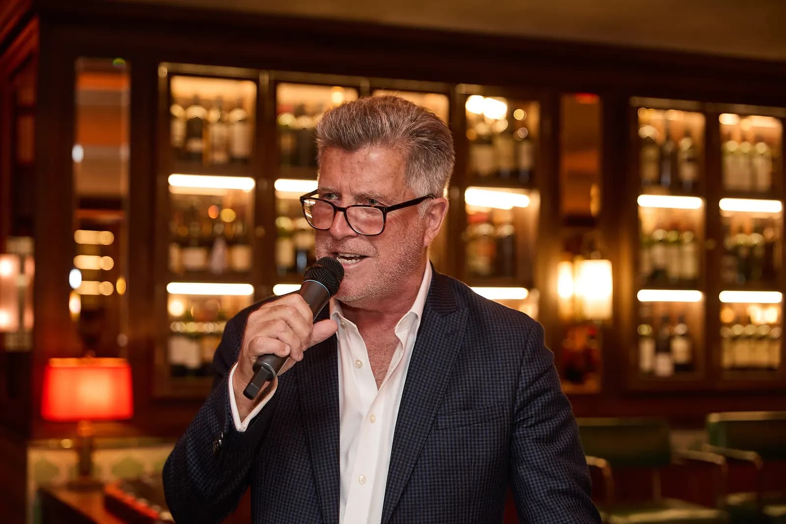A speaker with a microphone addressing the room