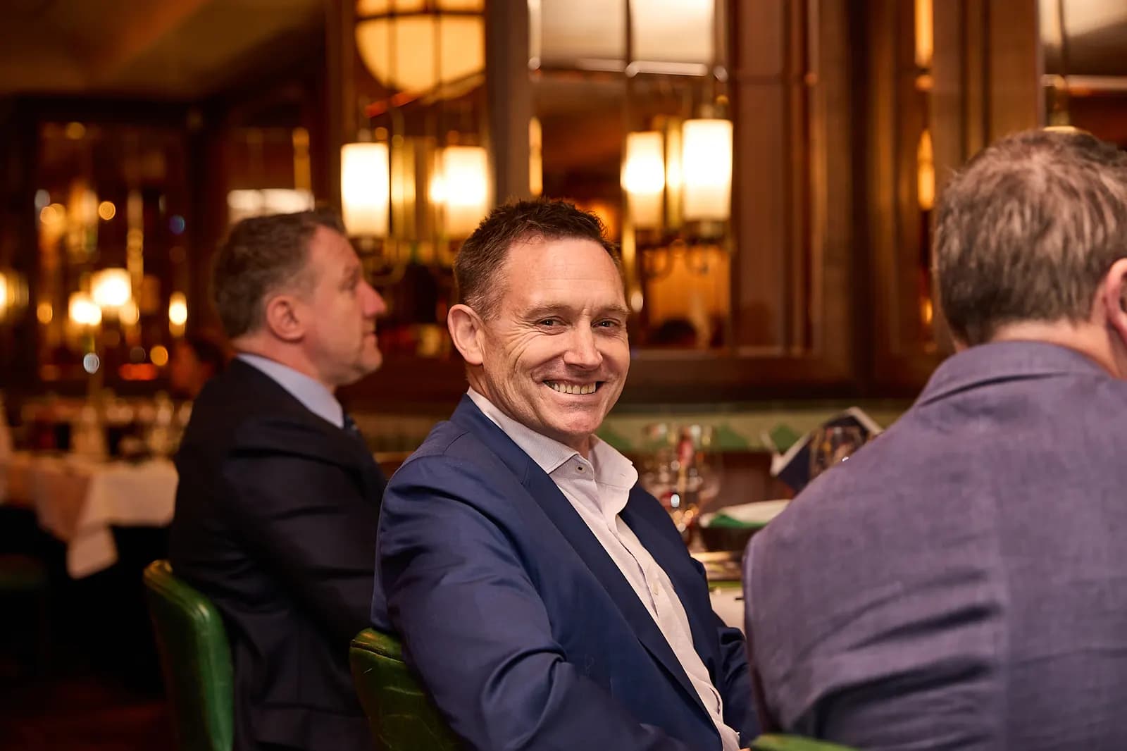 A guest smiling across the table