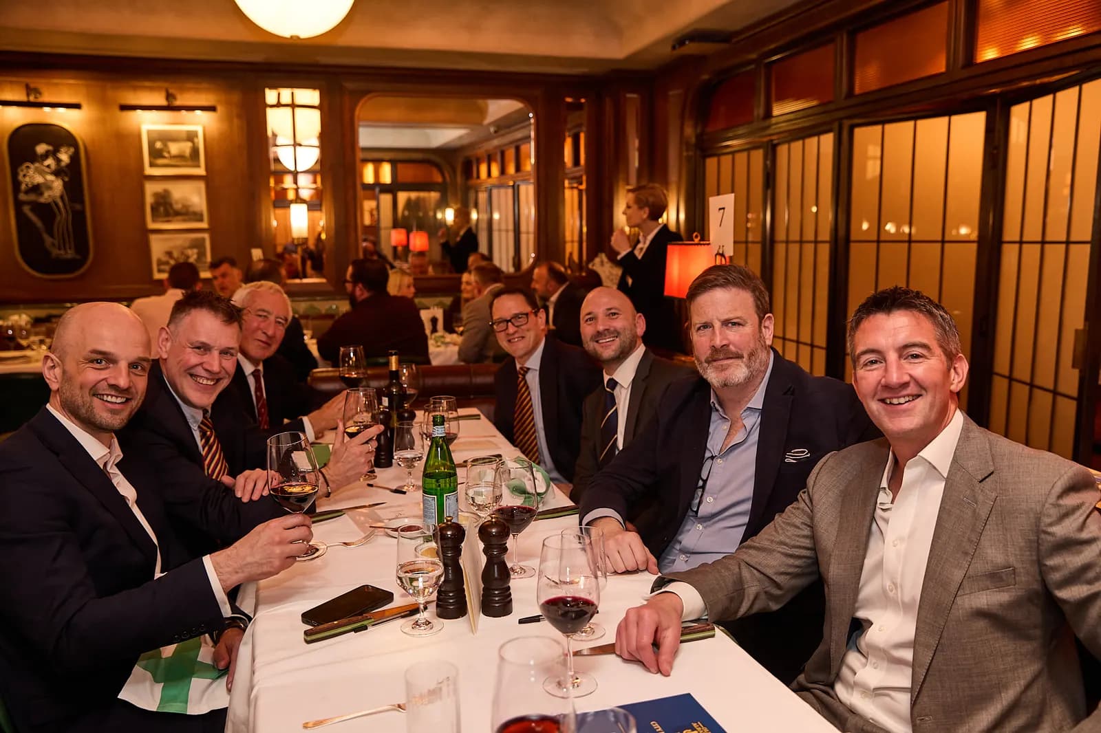 A long table of guests midway through lunch