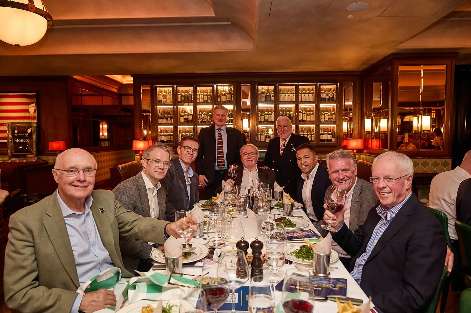 A long table of guests deep in conversation