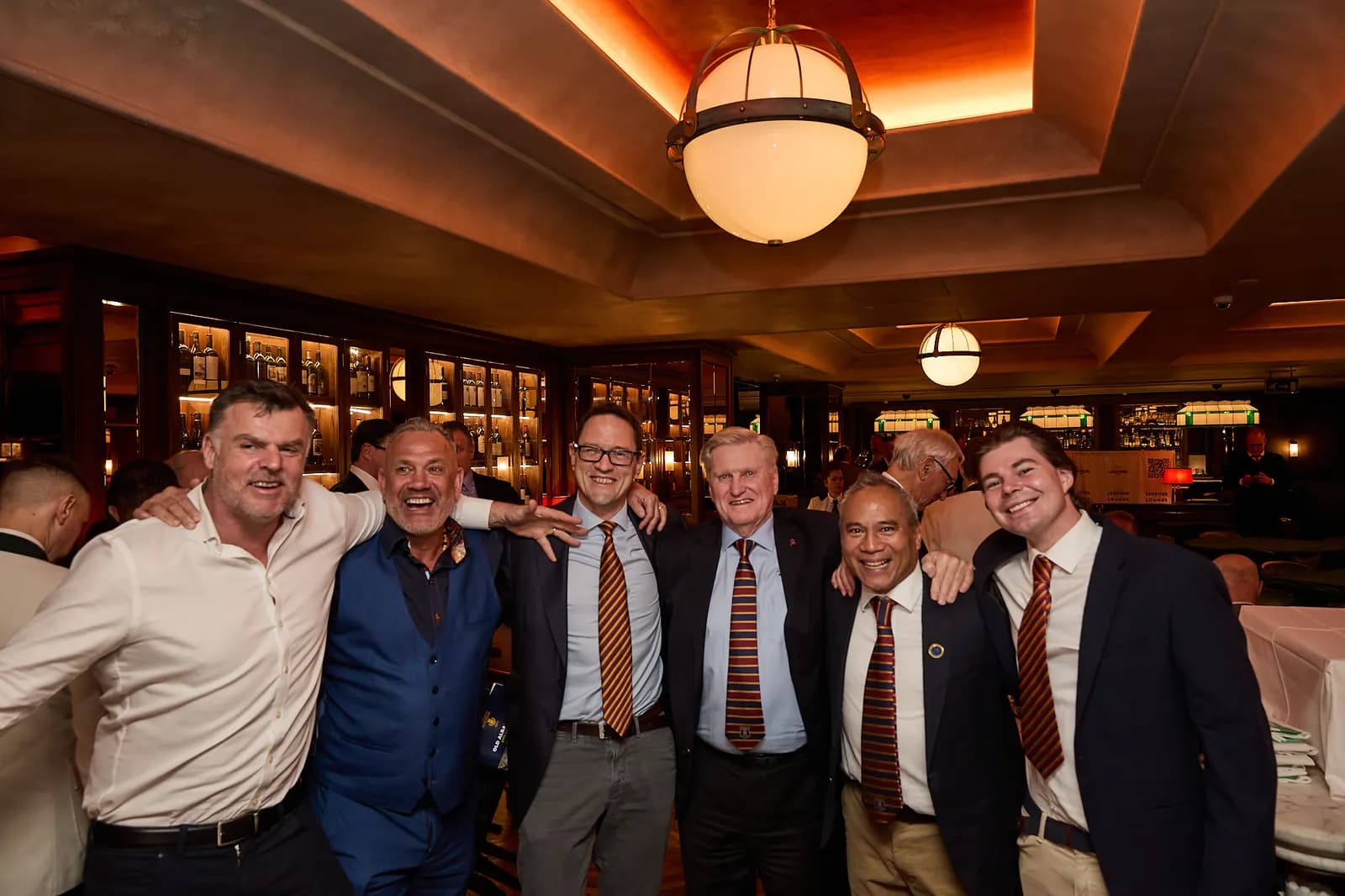 A row of guests arm in arm at the end of the afternoon